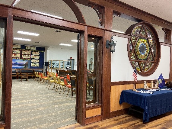 View of meeting room with large circle stained-glass window.